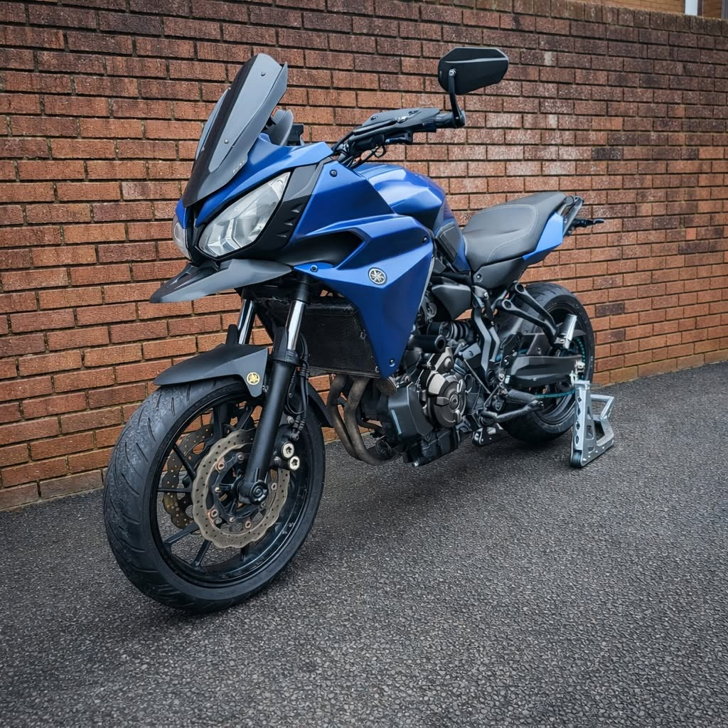 Blue Yamaha Tracer 700 2019 parked beside a brick wall
